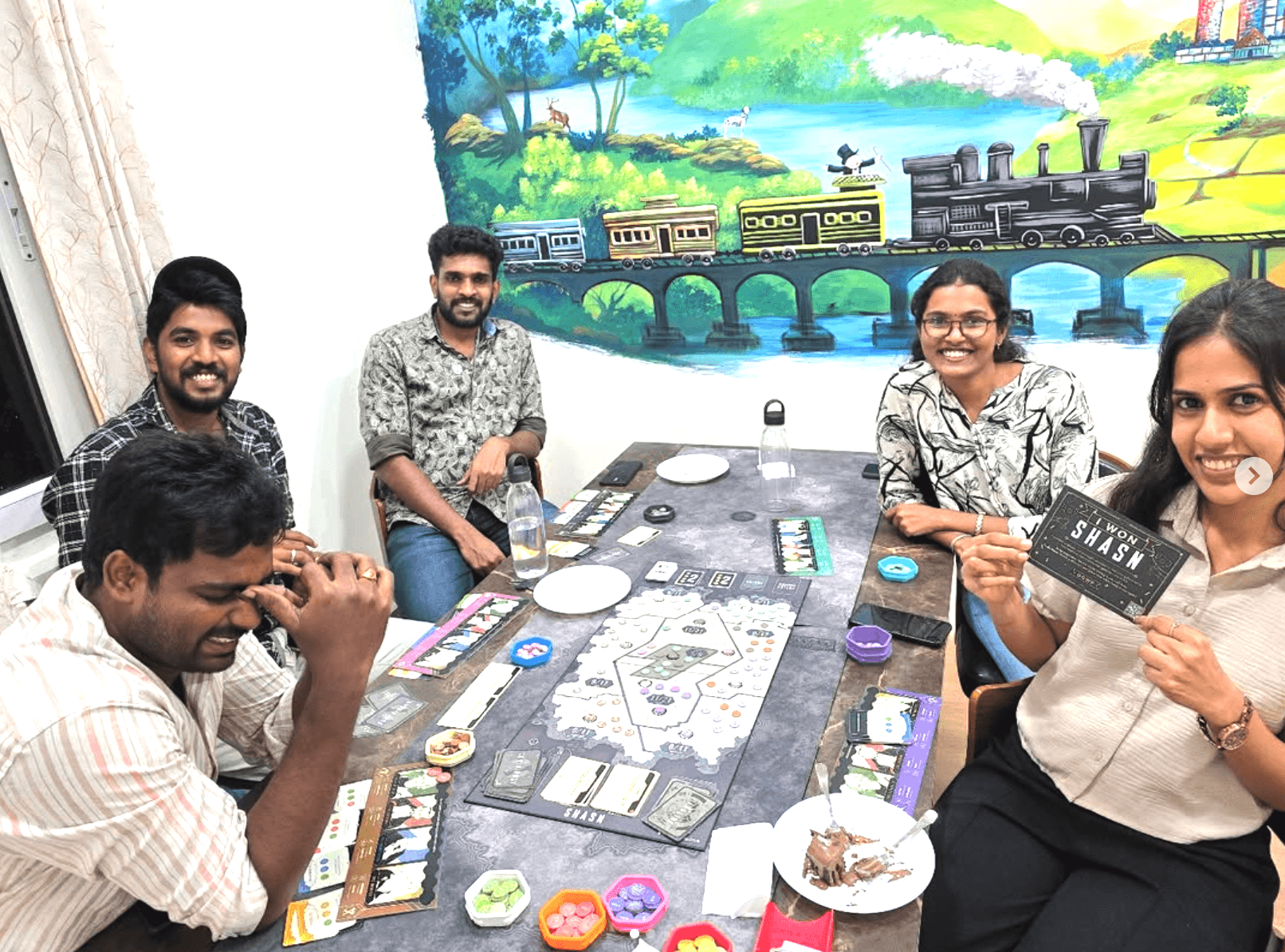 Friends playing board games at a cozy table